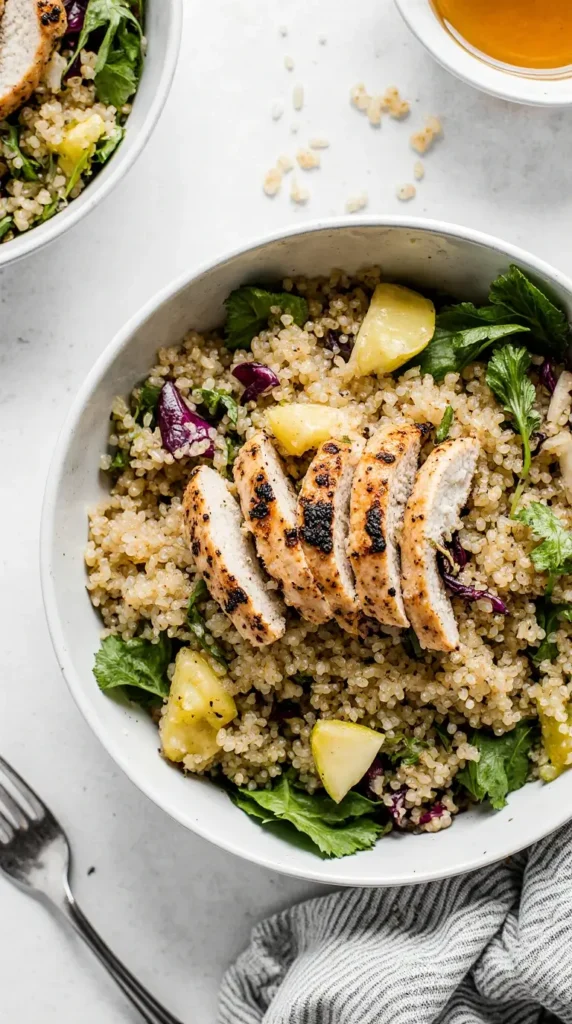 A close-up photorealistic image of a quinoa and grilled chicken salad in a white bowl with colorful vegetables.